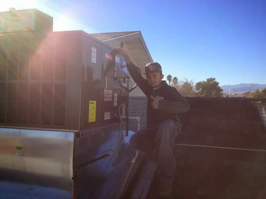 HVAC technician performing HVAC Inspection on a rooftop unit in East Windsor